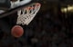 NBA篮球比赛中运动员飞身上篮，观众席灯光璀璨，比赛激烈进行